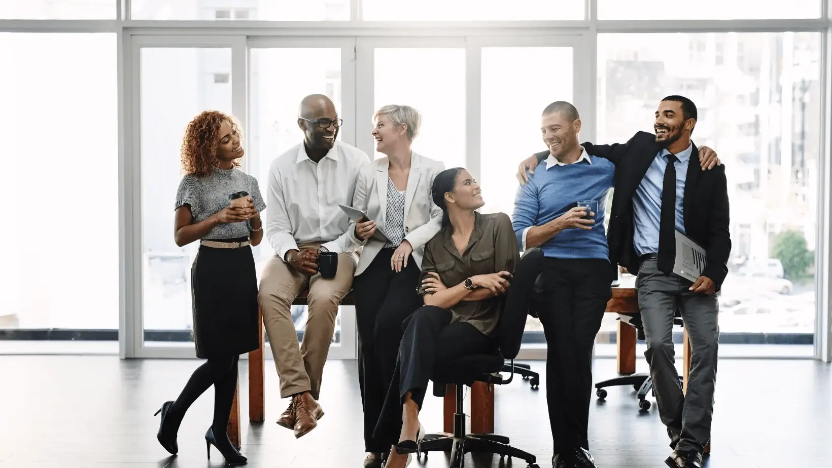 A diverse team enjoying a light moment at the office.
