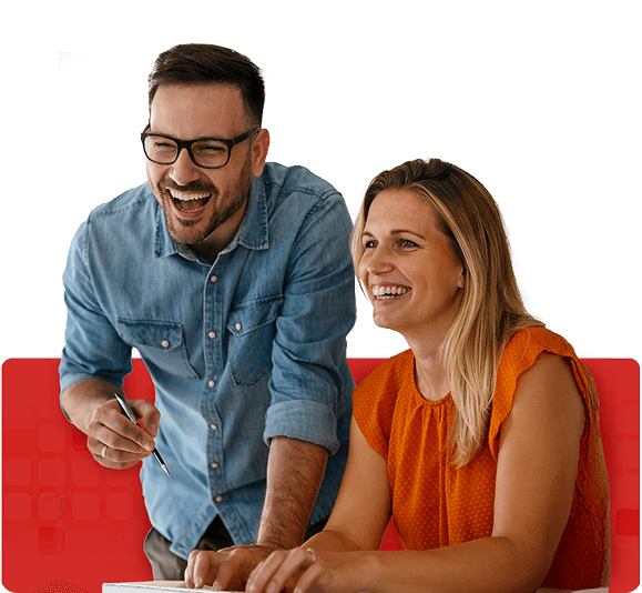 Two professionals collaborate at a table, actively discussing ideas over a notebook, set against a vibrant red background symbolizing energy and focus.