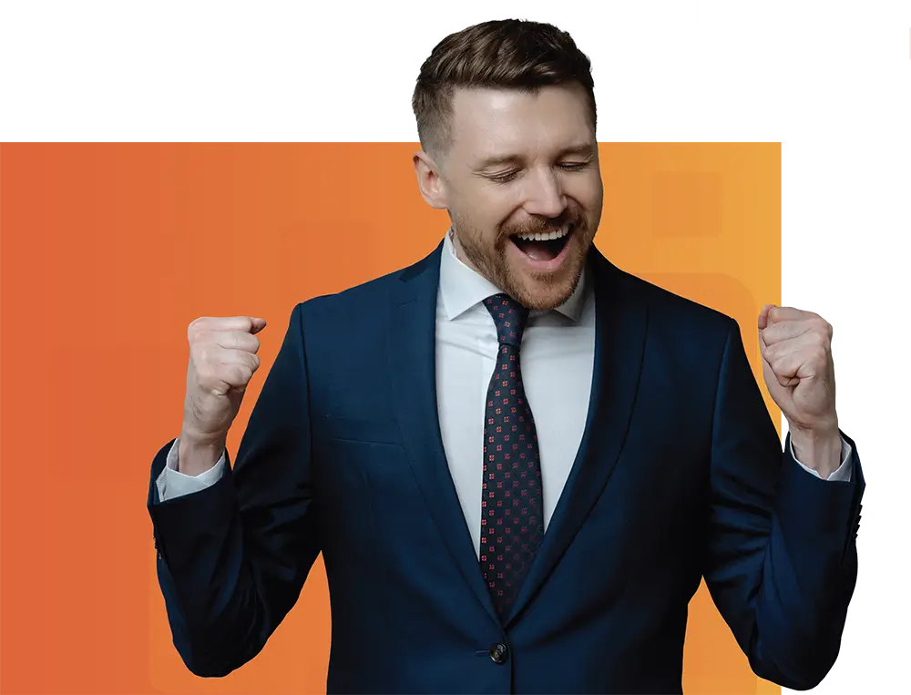 A businessman in a navy suit and tie raises his fists in a victorious gesture against a vibrant orange background, symbolizing success and achievement.